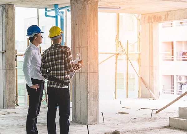 two workers reading a blueprint