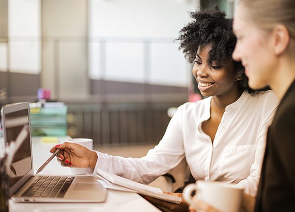 ladies reviewing information on a laptop