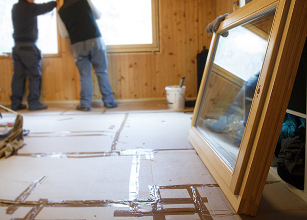 inside a building under construction with a large window leaning on a wall